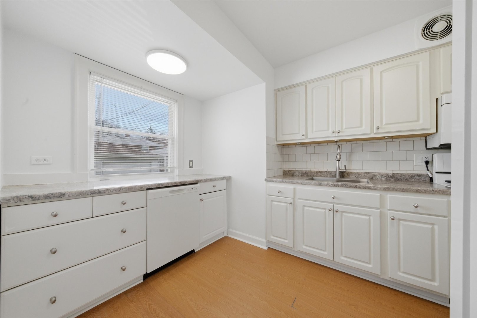 3941 North Mobile Avenue Chicago, IL 60634 - Photo 10 of 46 a kitchen with granite countertop white cabinets and a sink