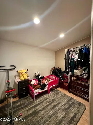 a bedroom with furniture and a flat screen tv