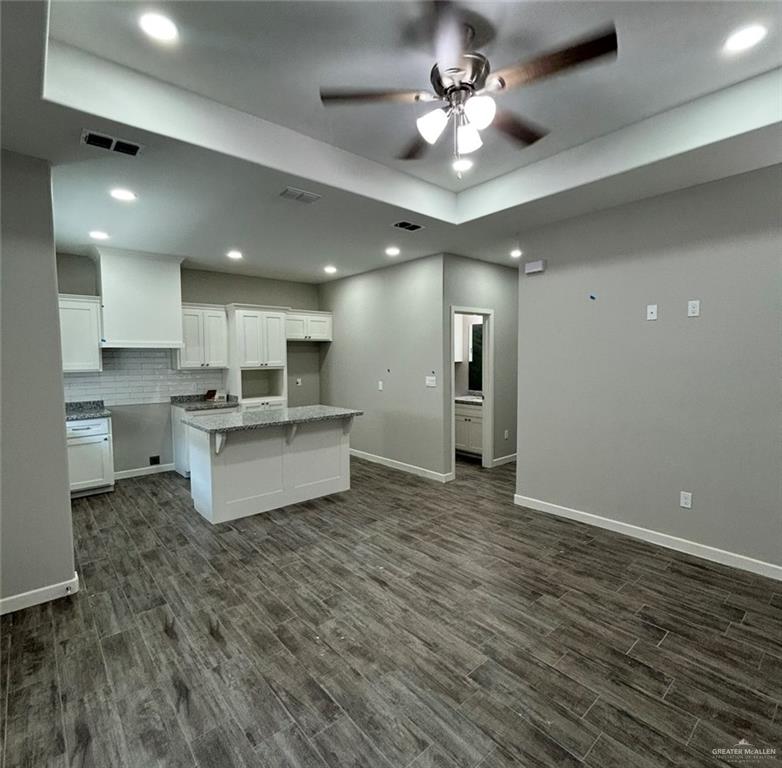 401 Bertha Avenue, Unit 2 Mission, TX 78572 - Photo 3 of 13 a large kitchen with kitchen island a stove a sink dishwasher and a refrigerator with wooden floor