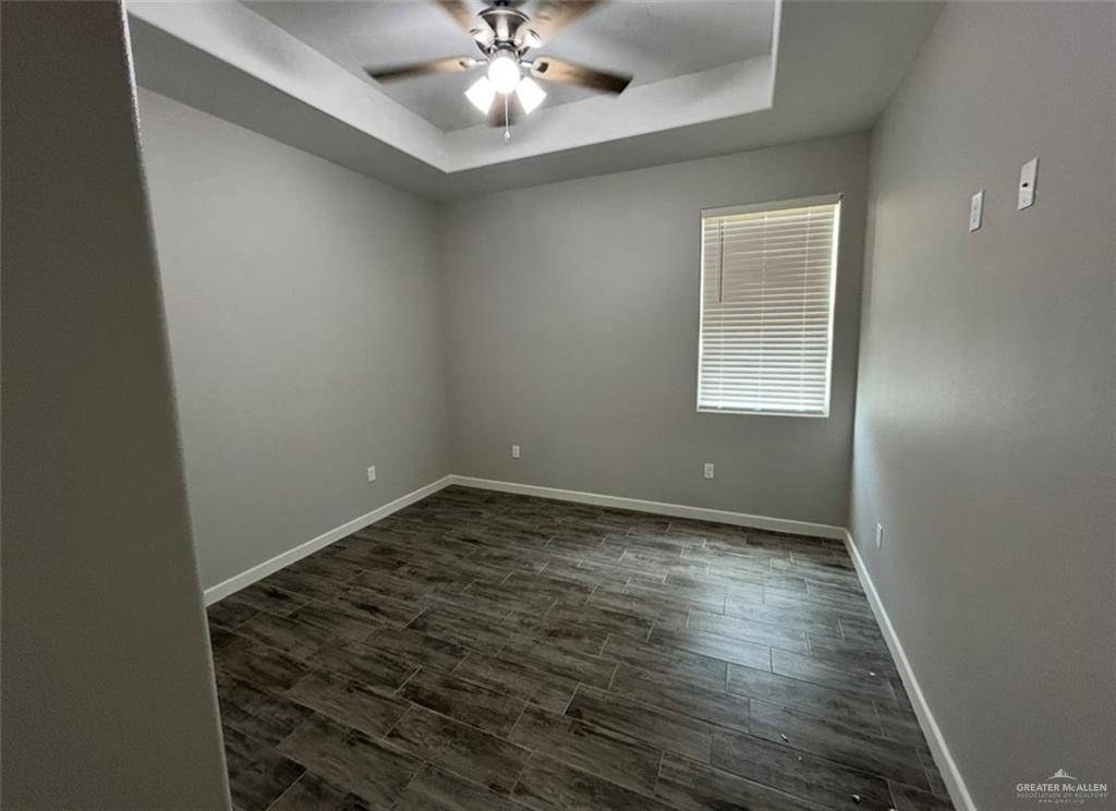 401 Bertha Avenue, Unit 2 Mission, TX 78572 - Photo 6 of 13 a view of an empty room with a chandelier fan