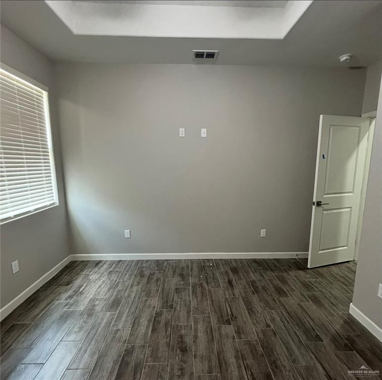 401 Bertha Avenue, Unit 2 Mission, TX 78572 - Photo 8 of 13 an empty room with wooden floor and a window