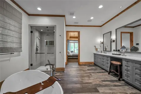 a spacious bathroom with a granite countertop sink a toilet a mirror and shower