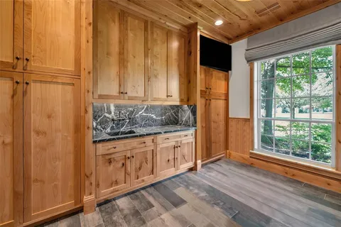 a bathroom with a granite countertop sink and large window