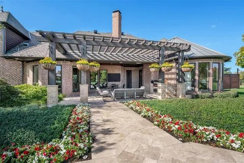 a view of a house with sitting area and garden