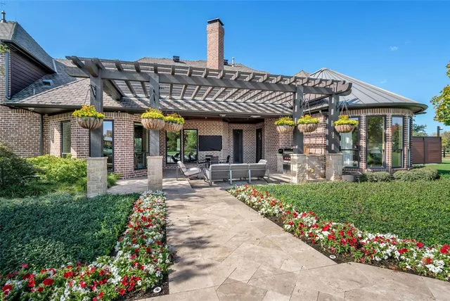a view of a house with sitting area and garden
