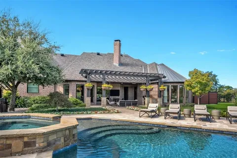 a front view of house with yard barbeque and outdoor seating