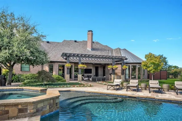 a front view of house with yard barbeque and outdoor seating