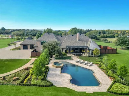 an aerial view of a house with swimming pool garden and patio