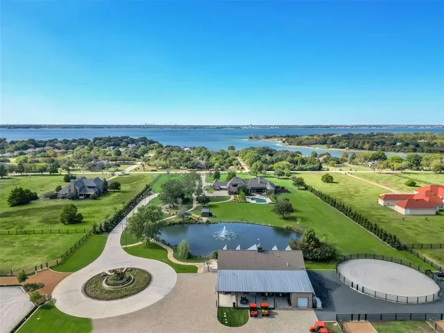 an aerial view of a house with garden space lake view and mountain view in back