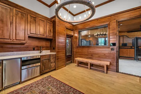 a view of a kitchen with stainless steel appliances granite countertop a stove and a refrigerator
