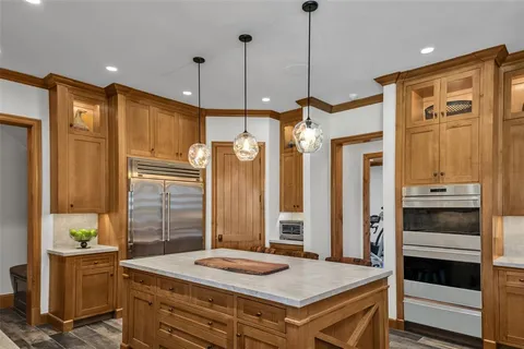 a kitchen that has a refrigerator a stove and a cabinets