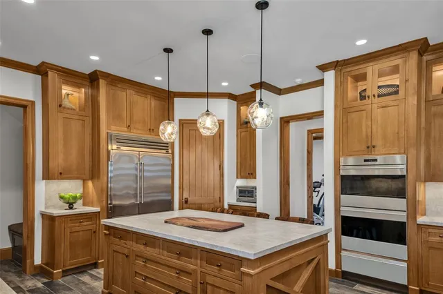 a kitchen that has a refrigerator a stove and a cabinets