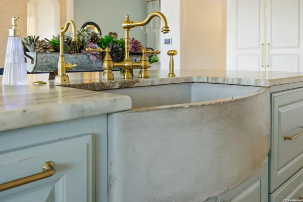 a bathroom with a sink and mirror with bathtub