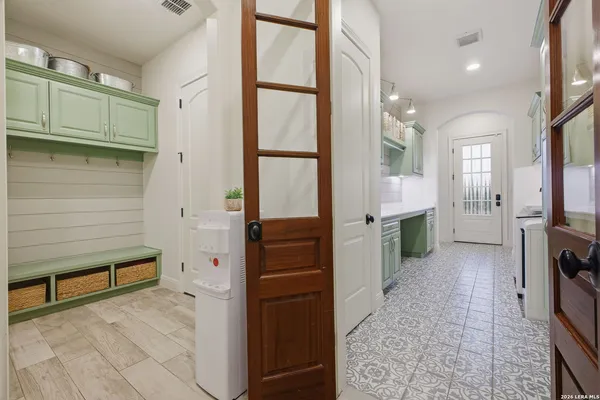 a bedroom with a bed and a chair with the bookshelf
