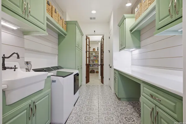 a bathroom with a granite countertop sink a toilet a mirror and bathtub