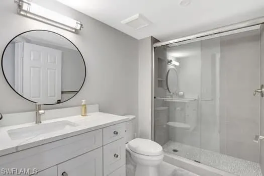 a bathroom with a sink a mirror a toilet and shower