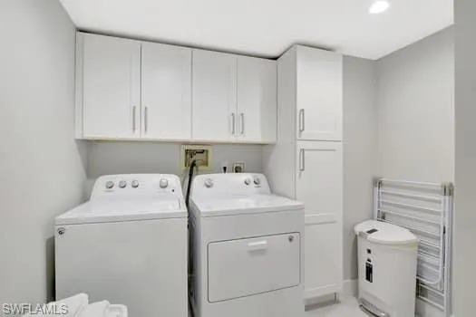 a view of storage and utility room with washer and dryer