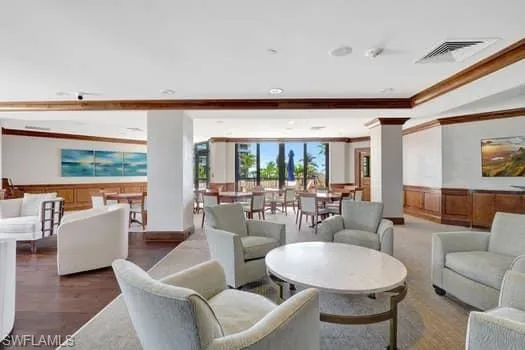 a living room with couches and a large window with garden view