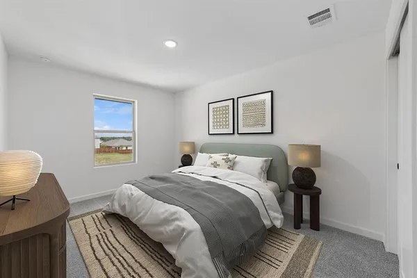 a bedroom with a bed and a painting on the wall