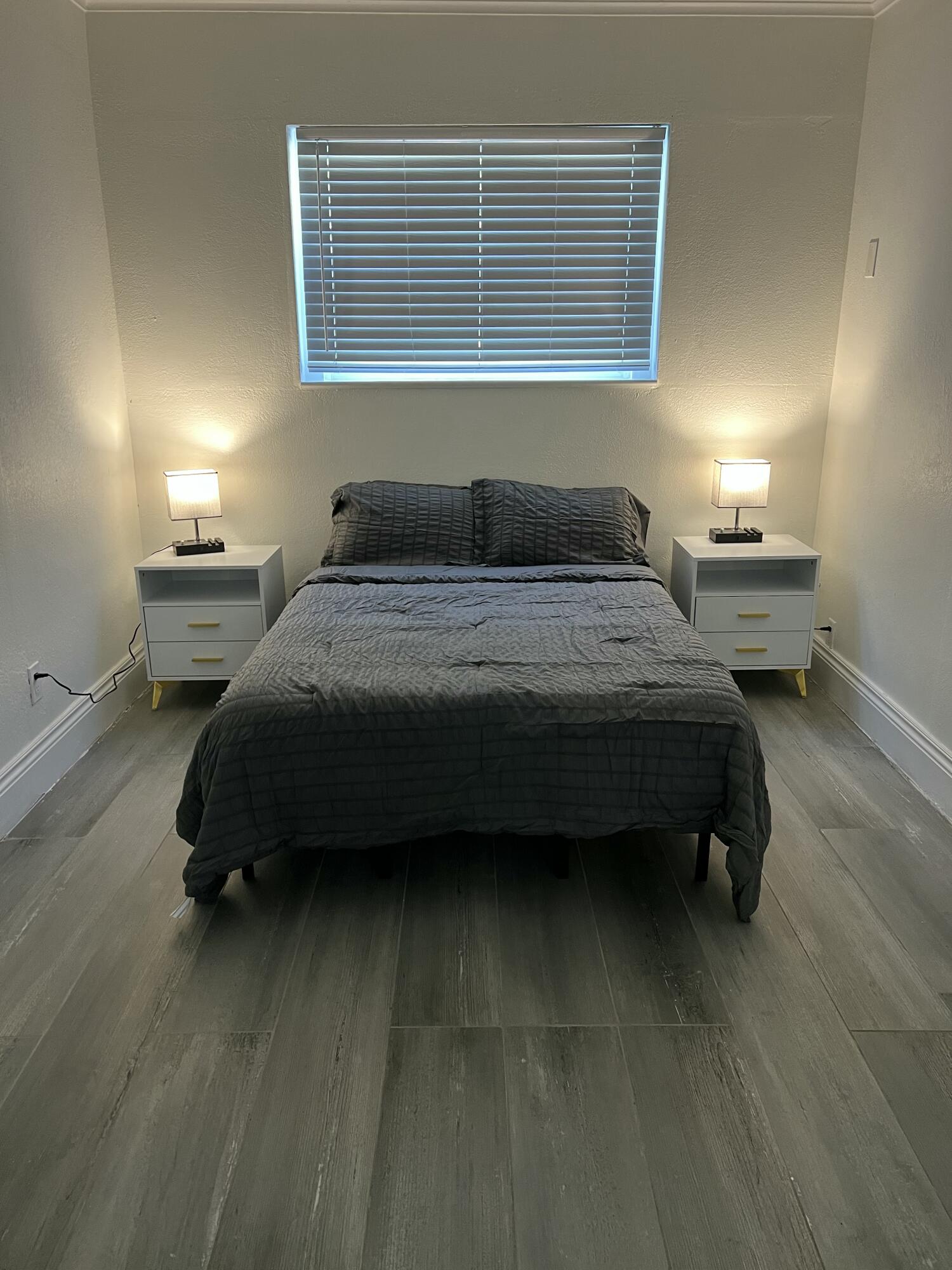 1016 Chipola Road, Unit A Fort Pierce, FL 34950 - Photo 7 of 9 a bedroom with a bed and a window