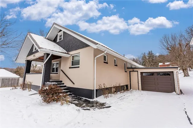 a view of a house with wooden fence