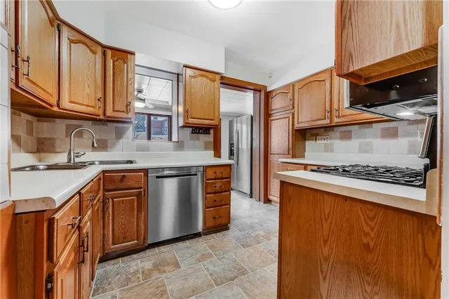 a kitchen with stainless steel appliances granite countertop a stove microwave and cabinets