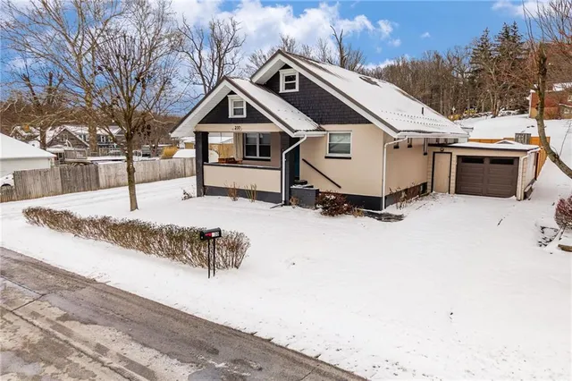 a view of a house with a yard covered in snow