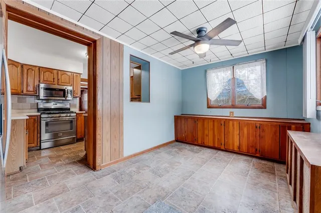 a view of empty room with stairs and wooden floor