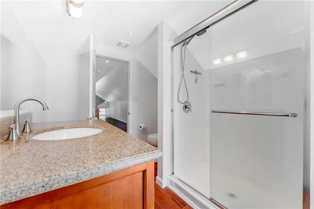 a bathroom with a sink toilet and shower