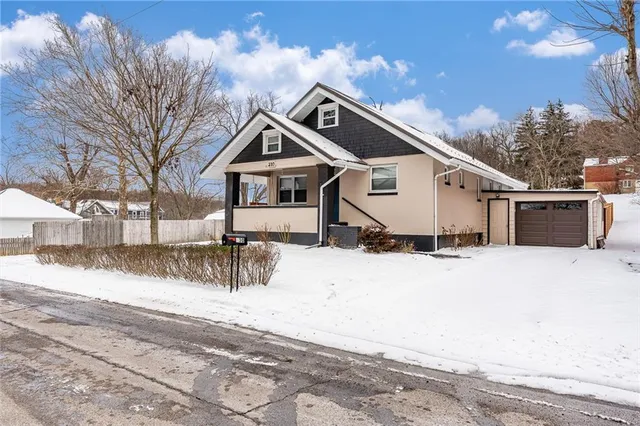 a view of a house with a yard covered in snow