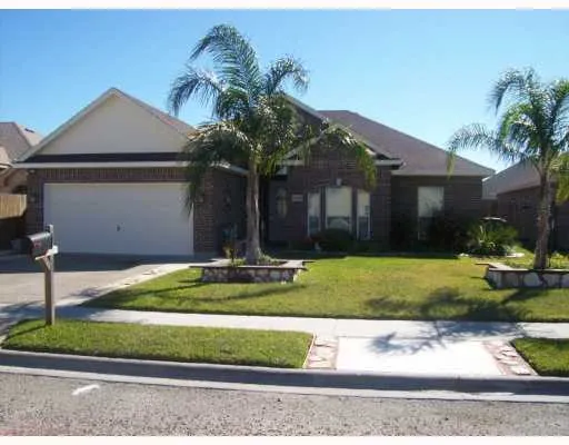 a front view of a house with a yard and potted plants