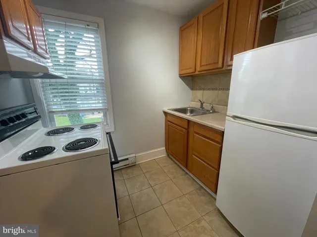 a kitchen with a stove a refrigerator and a sink