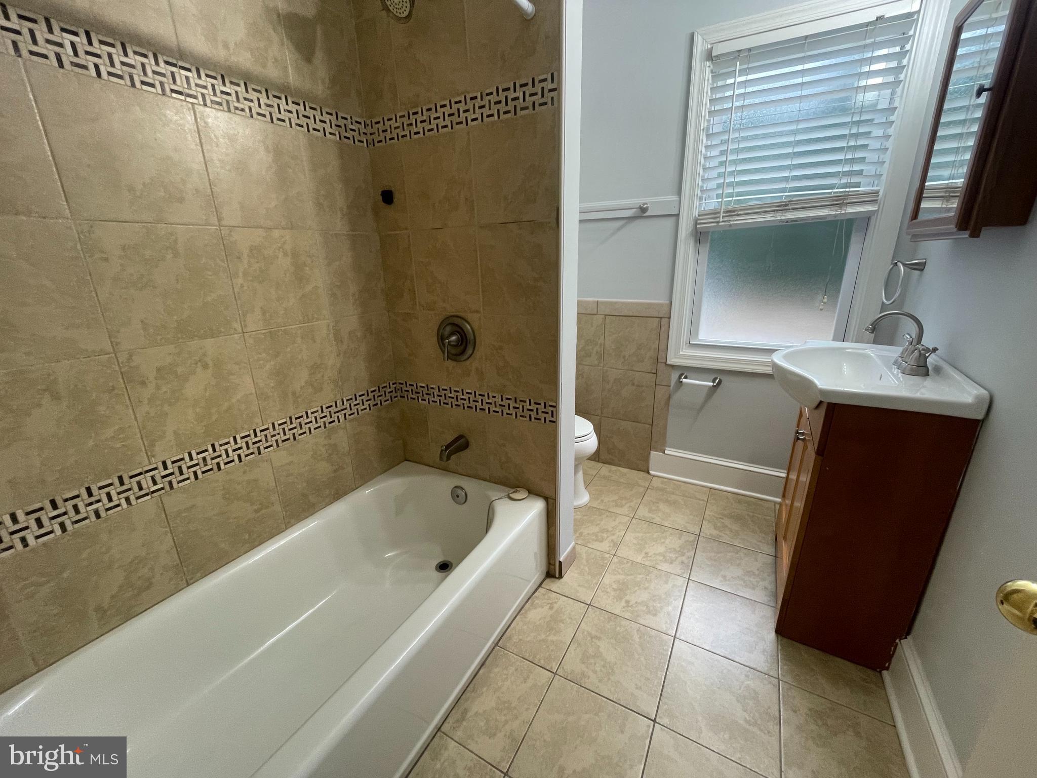 8627 1/2 Quentin Avenue Parkville, MD 21234 - Photo 8 of 11 a bathroom with a bathtub sink and toilet