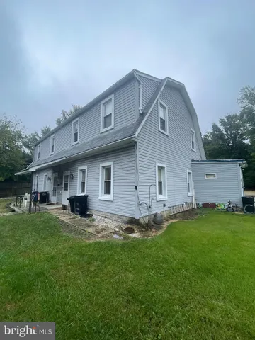 a big house with a big yard and large trees