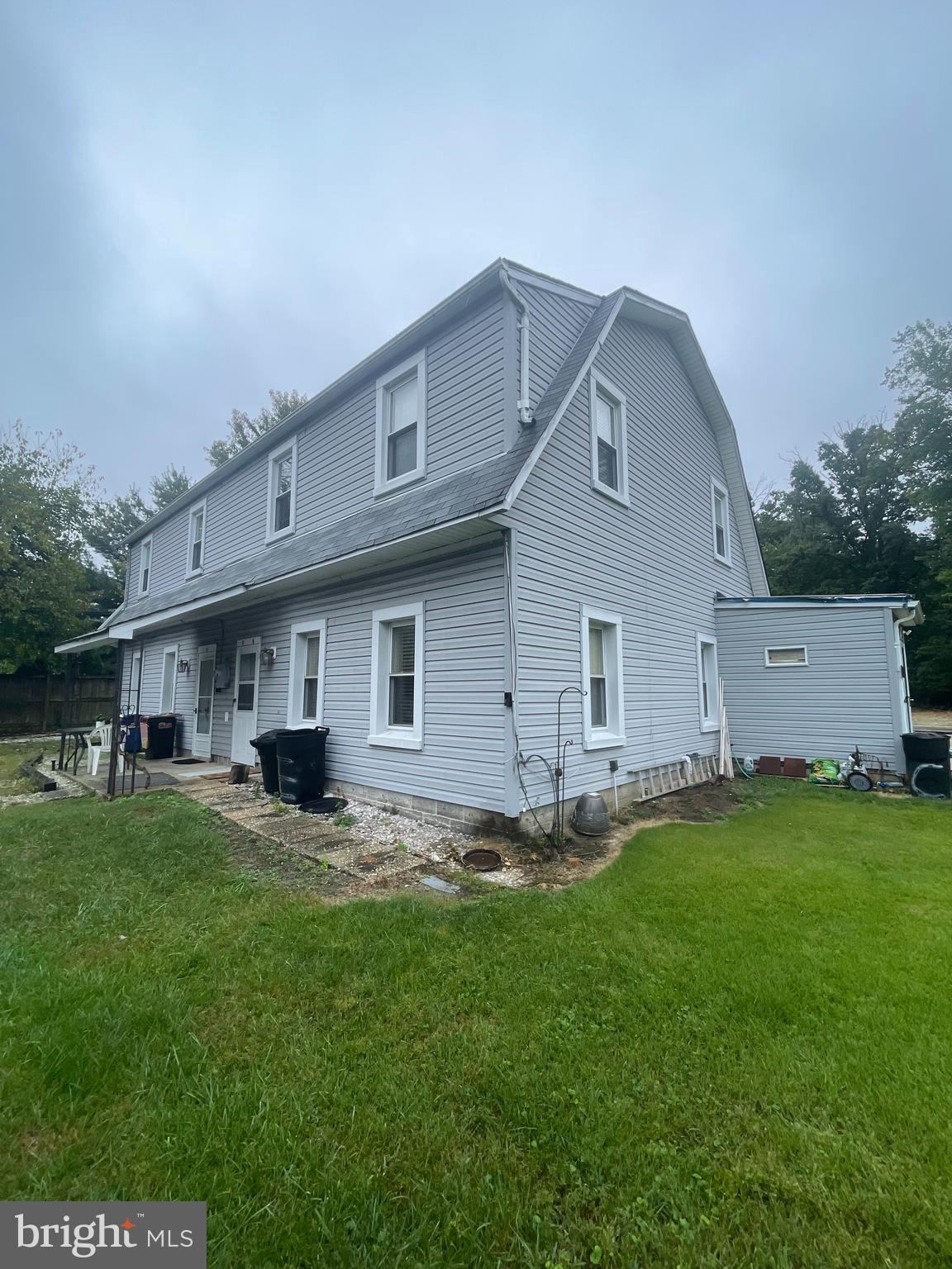 8627 1/2 Quentin Avenue Parkville, MD 21234 - Photo 10 of 11 a big house with a big yard and large trees