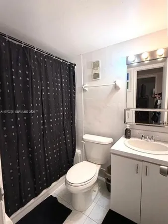 a bathroom with a sink toilet vanity and shower