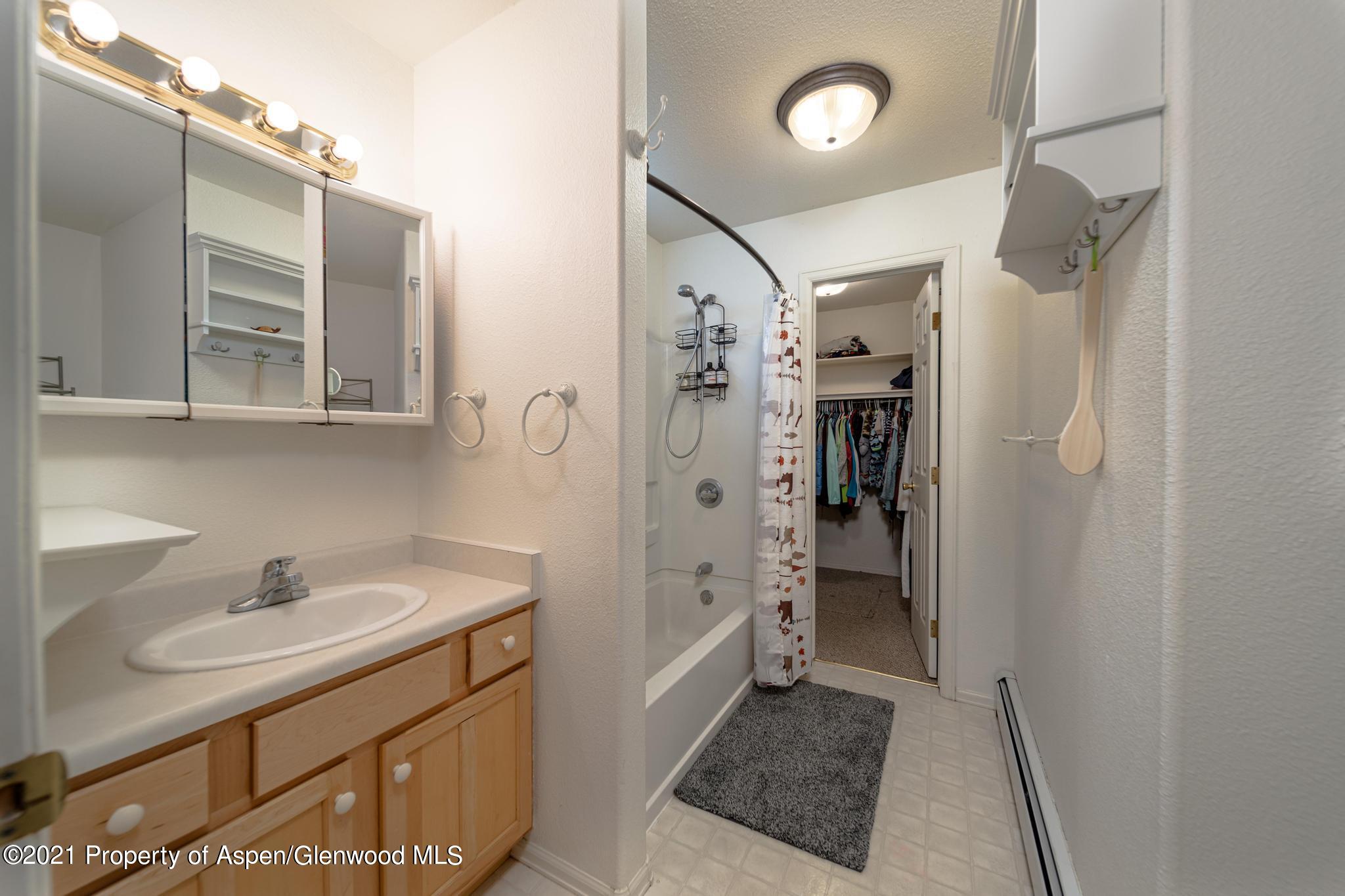 452 Evergreen Drive Rifle, CO 81650 - Photo 11 of 22 a bathroom with a sink shower and a mirror