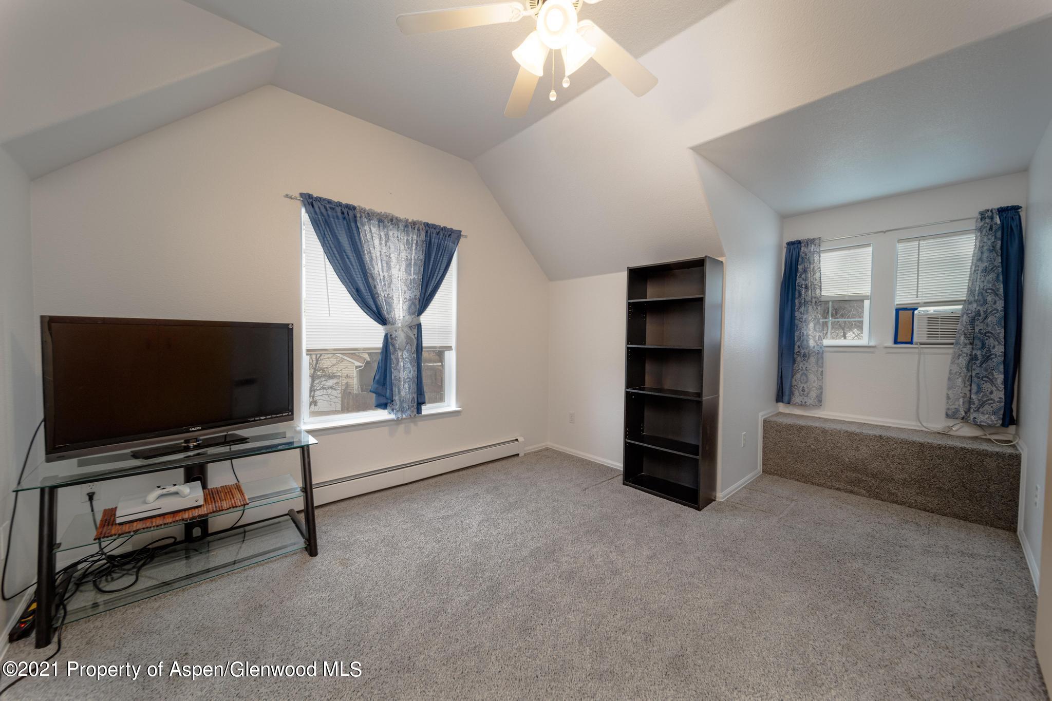 452 Evergreen Drive Rifle, CO 81650 - Photo 16 of 22 a living room with furniture and a flat screen tv