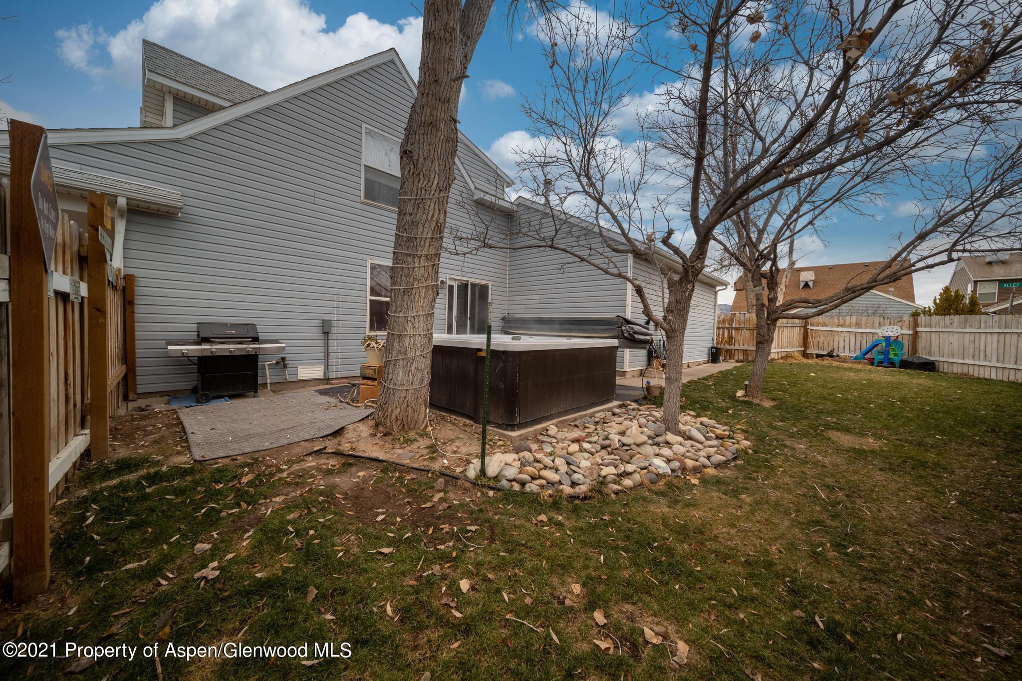 452 Evergreen Drive Rifle, CO 81650 - Photo 18 of 22 a view of a backyard with table and chairs and a fire pit