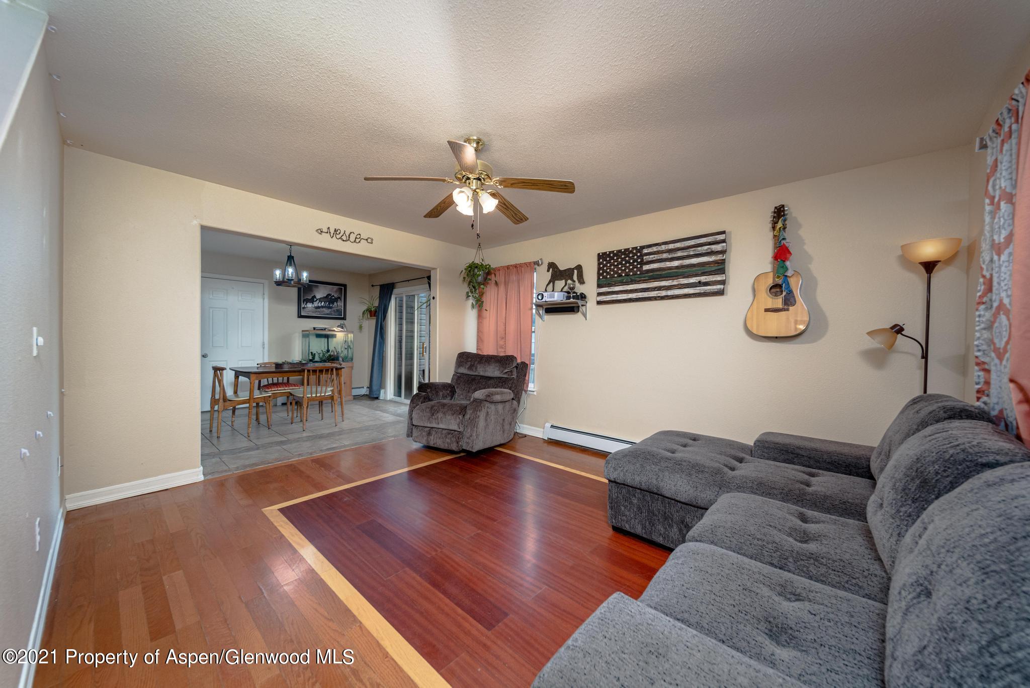 452 Evergreen Drive Rifle, CO 81650 - Photo 5 of 22 a living room with furniture and a chandelier