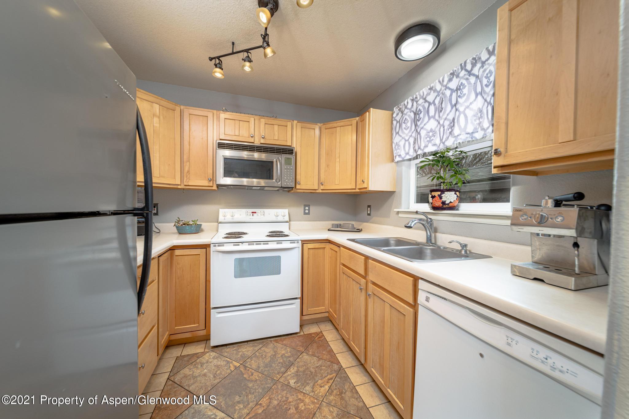 452 Evergreen Drive Rifle, CO 81650 - Photo 7 of 22 a kitchen with a white cabinets and white appliances