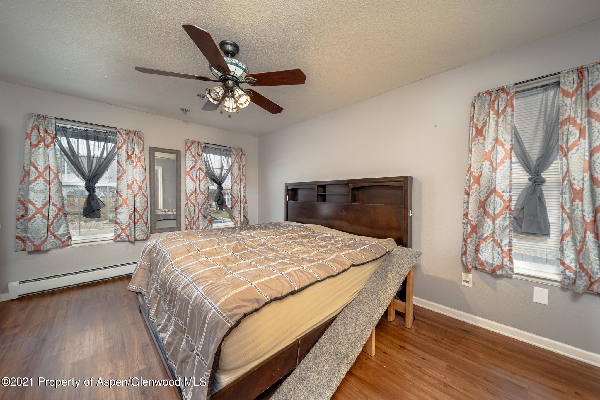 452 Evergreen Drive Rifle, CO 81650 - Photo 9 of 22 a bed sitting in a bedroom next to a window