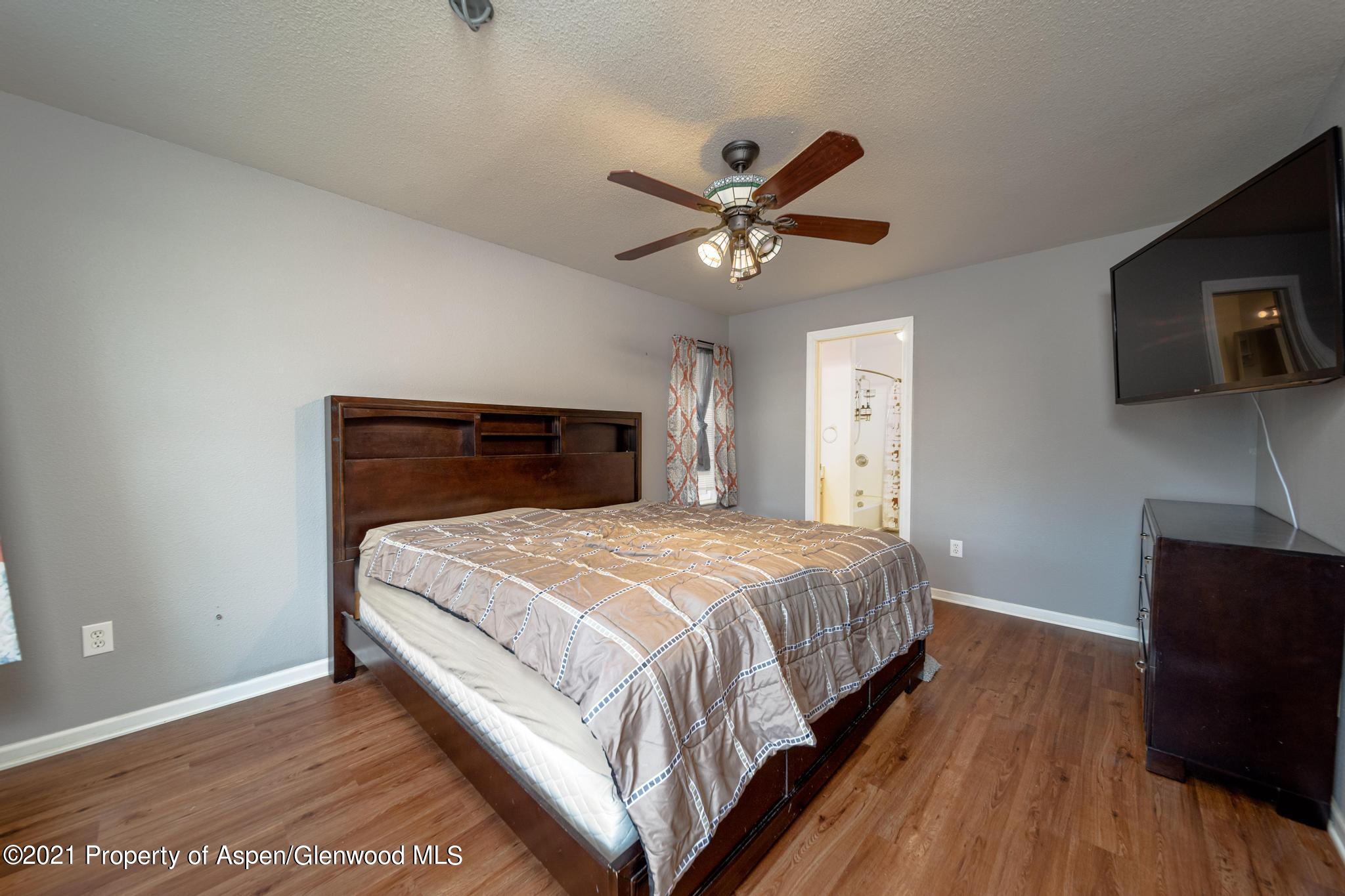 452 Evergreen Drive Rifle, CO 81650 - Photo 10 of 22 a bedroom with a bed and a tv