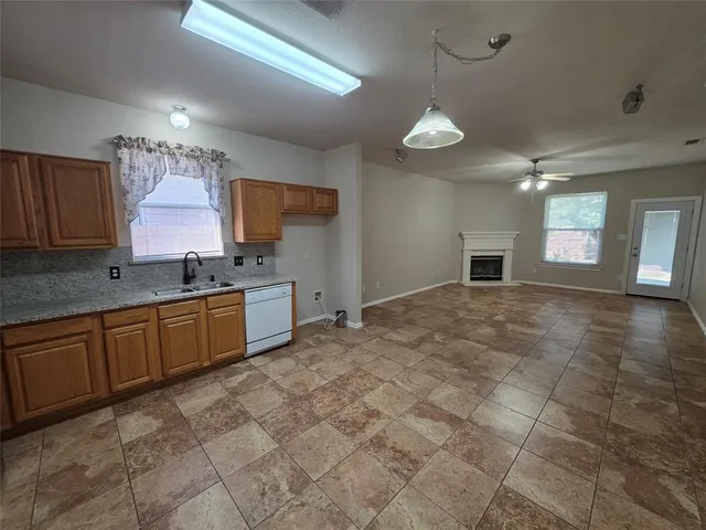 a kitchen with a sink a stove top oven and cabinets