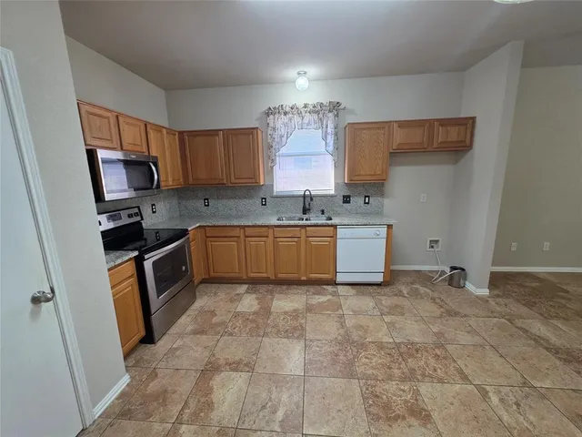 a view of a livingroom with a ceiling fan window and a fireplace