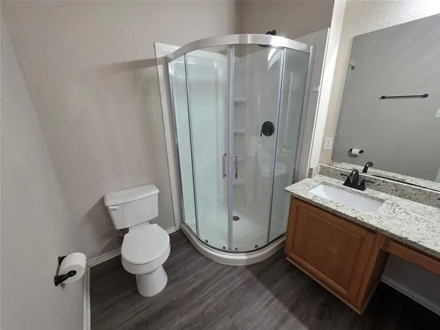a bathroom with a granite countertop tub sink and mirror