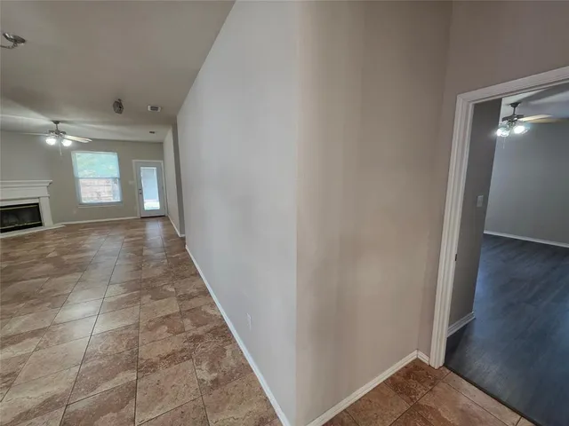 a large kitchen with cabinets and wooden floor