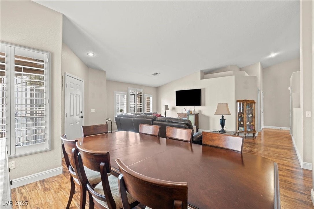 9031 West Viking Road Las Vegas, NV 89147 - Photo 10 of 33 Dining area with baseboards, lofted ceiling, and wood finished floors
