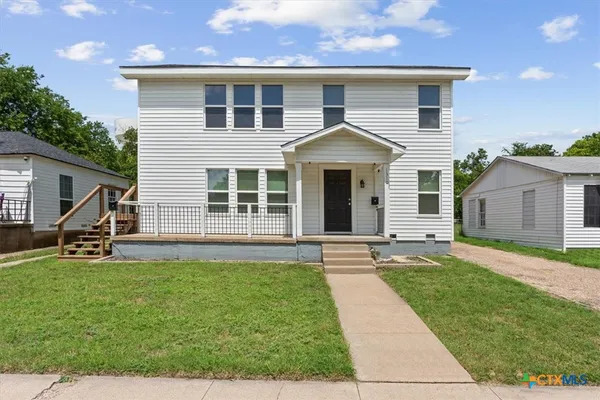 a front view of a house with a yard