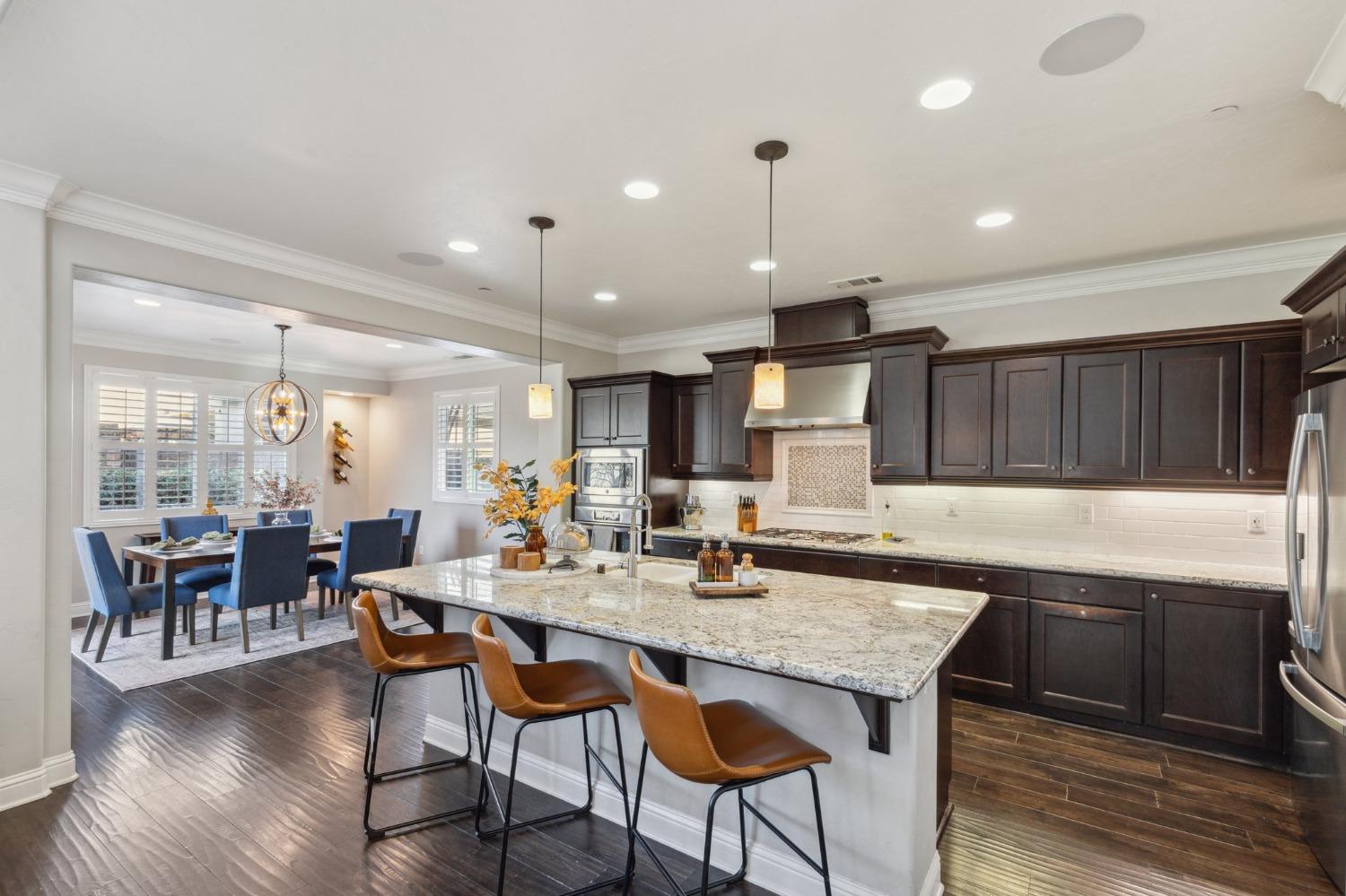 4217 Salem Lane Clovis, CA 93619 - Photo 12 of 57 a kitchen with a dining table chairs and wooden floor